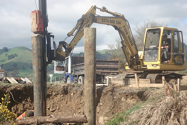 Select bridges pile driving heavy machinery driving in oversized piles.